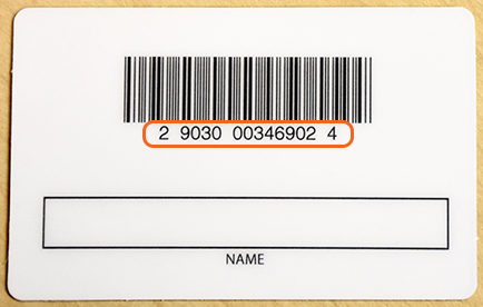 A library card with its card numbers highlighted, directly below its bar code on the back of the card.